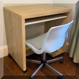 F31. Desk with keyboard tray and plastic desk chair. 